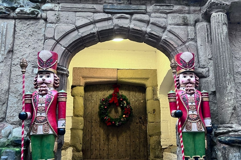 photo taken outside castle door to the Great Hall and porch, with a Christmas wreath and two nutcracker statues