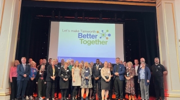 group photo on Assembly Rooms stage of partners from local services