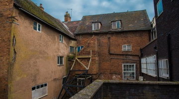 old building from the back with an outside staircase and old windows